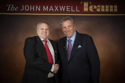 Jay Olivo, founder of Leadership TeamBuilder, standing with Dr. John C. Maxwell